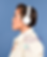 Side view of a woman wearing headphones and listening to music.